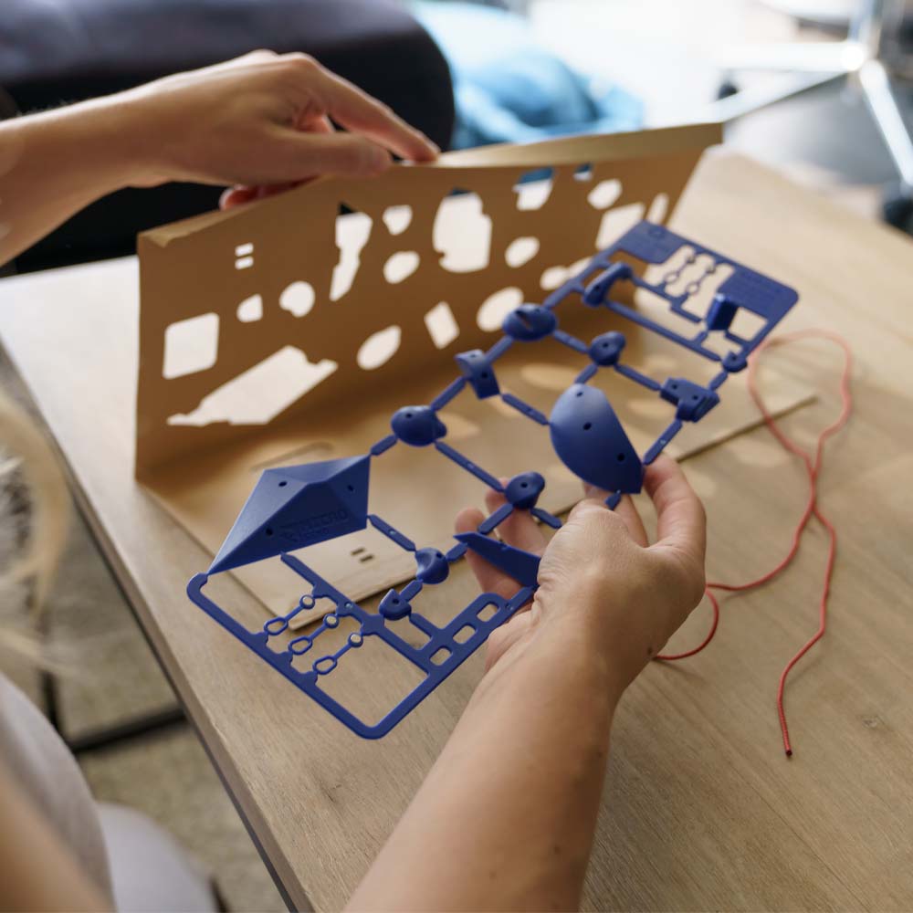 Hands unpacking blue micro send