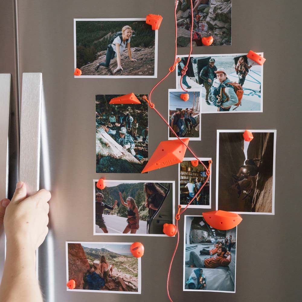 Orange micro send holds and rope on fridge with photos